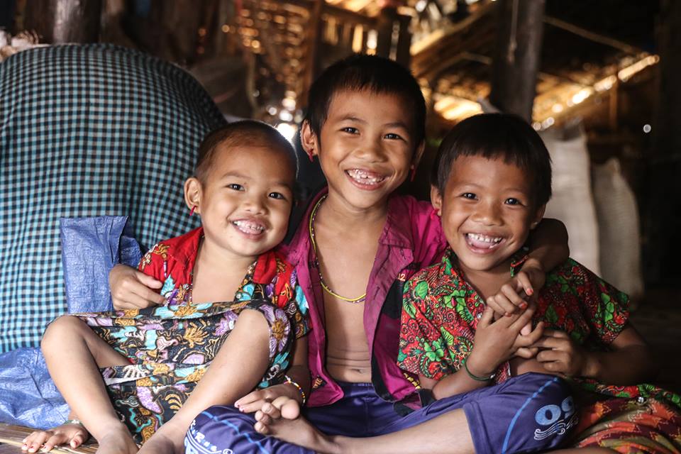 Three Asian children smiling